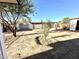 This backyard features desert landscaping, a block fence, and space for various outdoor activities at 7754 W Mitchell Dr, Phoenix, AZ 85033