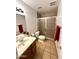 Modern bathroom with tile floors, glass shower, and modern fixtures at 7754 W Mitchell Dr, Phoenix, AZ 85033