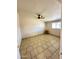 Airy bedroom featuring neutral walls, tile floors, and a ceiling fan at 7754 W Mitchell Dr, Phoenix, AZ 85033