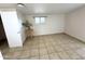 Bright, clean bedroom with tile floor, window, and a small plant at 7754 W Mitchell Dr, Phoenix, AZ 85033