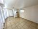 Cozy bedroom with tile flooring, bright window, and plant decoration at 7754 W Mitchell Dr, Phoenix, AZ 85033