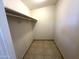 Walk in closet with tile floor and hanging rod at 7754 W Mitchell Dr, Phoenix, AZ 85033