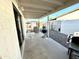 Cozy, covered patio with a white iron table set and an outdoor kitchen area perfect for relaxation and entertaining at 7754 W Mitchell Dr, Phoenix, AZ 85033