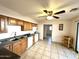 Well-lit kitchen with tile floor, plentiful cabinetry, and white appliances at 7754 W Mitchell Dr, Phoenix, AZ 85033