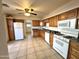 Bright kitchen with oak cabinets, tile floors, and white appliances at 7754 W Mitchell Dr, Phoenix, AZ 85033