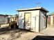 Outdoor shed with a convenient entry door and adjacent dog house, perfect for storage and pet comfort at 7754 W Mitchell Dr, Phoenix, AZ 85033