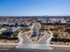 This aerial view showcases a meticulously planned community with a central roundabout and beautiful desert landscaping under a clear blue sky at 8043 E Jaeger St, Mesa, AZ 85207