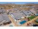 Aerial view of a Primary-planned community featuring numerous homes, swimming pools, and mountain views at 8043 E Jaeger St, Mesa, AZ 85207