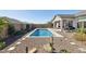Private backyard featuring a sparkling pool, desert landscaping, and a neutral colored patio at 8043 E Jaeger St, Mesa, AZ 85207