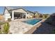 Backyard featuring a sparkling pool and a neutral colored patio with outdoor grill and seating at 8043 E Jaeger St, Mesa, AZ 85207