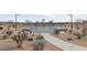 Outdoor basketball court featuring a blue and green surface with benches and desert landscaping at 8043 E Jaeger St, Mesa, AZ 85207