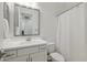 Clean bathroom with a shower featuring a white vanity, framed mirror, and modern sink at 8043 E Jaeger St, Mesa, AZ 85207