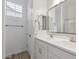 Clean bathroom featuring double sinks, bright lighting, and a large mirror at 8043 E Jaeger St, Mesa, AZ 85207