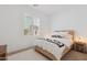 Bright bedroom features a bed with throw pillows, a window with shutters, and a wood nightstand at 8043 E Jaeger St, Mesa, AZ 85207