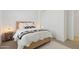 Minimalist bedroom with natural wood bed, sliding closet doors and lamps on nightstands at 8043 E Jaeger St, Mesa, AZ 85207