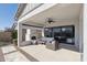 Covered patio with a cozy fireplace, comfortable seating, and view into the backyard at 8043 E Jaeger St, Mesa, AZ 85207