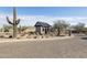 Neighborhood entrance featuring desert landscaping and a guardhouse at Monteluna at 8043 E Jaeger St, Mesa, AZ 85207