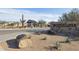 Community entrance featuring desert landscaping and a charming guardhouse at Monteluna at 8043 E Jaeger St, Mesa, AZ 85207