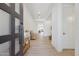 Bright entryway featuring wood-look tile floors, white walls, modern lighting, and decorative furniture piece at 8043 E Jaeger St, Mesa, AZ 85207