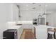 An expansive kitchen features white cabinets, an island, stainless appliances, and hardwood style floors at 8043 E Jaeger St, Mesa, AZ 85207