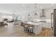 Open-concept kitchen with a center island, stainless steel appliances, and seamless flow to the living area at 8043 E Jaeger St, Mesa, AZ 85207