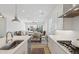 Bright kitchen with stainless steel appliances, quartz countertops, and views of the living room at 8043 E Jaeger St, Mesa, AZ 85207