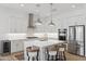 Bright kitchen featuring white cabinets, stainless steel appliances, and a central island with bar stool seating at 8043 E Jaeger St, Mesa, AZ 85207