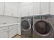 Functional laundry room with washer, dryer, and built-in cabinetry for storage at 8043 E Jaeger St, Mesa, AZ 85207