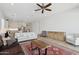 Bright living room featuring a ceiling fan, hardwood floors, and an open floor plan at 8043 E Jaeger St, Mesa, AZ 85207