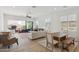 Open-concept living room featuring tile floors, ceiling fan, a dining table, and lots of natural light at 8043 E Jaeger St, Mesa, AZ 85207