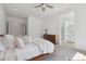 Sunlit main bedroom with a ceiling fan and a glimpse into the ensuite bathroom at 8043 E Jaeger St, Mesa, AZ 85207
