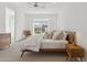 Bright bedroom featuring a ceiling fan, large window with shutters, and mid-century modern furniture at 8043 E Jaeger St, Mesa, AZ 85207