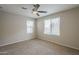 Bedroom featuring carpet, ceiling fan, and a large window with white blinds at 8224 W Albeniz Pl, Phoenix, AZ 85043