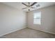 Bright bedroom with a ceiling fan and a window overlooking the neighborhood at 8224 W Albeniz Pl, Phoenix, AZ 85043