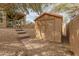 Cozy backyard featuring a storage shed, patio, and hardscaped walkway, perfect for outdoor enjoyment at 8340 E Rowel Rd, Scottsdale, AZ 85255
