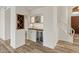 Wet bar area features custom cabinets, a wine refrigerator and a wine rack at 8340 E Rowel Rd, Scottsdale, AZ 85255
