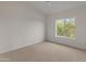 Empty bedroom featuring neutral carpet, a ceiling fan, and a window with mountain views at 8340 E Rowel Rd, Scottsdale, AZ 85255