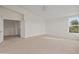 Spacious bedroom featuring neutral carpet, a ceiling fan, and sunny windows at 8340 E Rowel Rd, Scottsdale, AZ 85255
