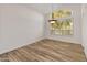 Dining room area with natural light, wood-look flooring, and stylish pendant lighting at 8340 E Rowel Rd, Scottsdale, AZ 85255