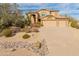 Elegant two-story home with a three-car garage and desert landscaping at 8340 E Rowel Rd, Scottsdale, AZ 85255