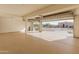 Bright, open garage with epoxy flooring and access to the driveway, offering convenience and functionality at 8340 E Rowel Rd, Scottsdale, AZ 85255