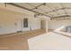 Spacious garage with epoxy flooring, utility sink, and ample storage, perfect for vehicles and hobbies at 8340 E Rowel Rd, Scottsdale, AZ 85255