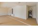 Spacious garage with epoxy floors, water heater, and access door at 8340 E Rowel Rd, Scottsdale, AZ 85255