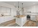 Bright kitchen featuring white cabinetry, a subway tile backsplash and granite countertops at 8340 E Rowel Rd, Scottsdale, AZ 85255