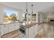 Kitchen featuring a large island, granite counters, stainless appliances, and natural light at 8340 E Rowel Rd, Scottsdale, AZ 85255