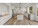Spacious kitchen with a large island, stainless steel appliances, and wood-style flooring at 8340 E Rowel Rd, Scottsdale, AZ 85255