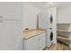Functional laundry room with modern appliances, countertop space, and storage cabinets at 8340 E Rowel Rd, Scottsdale, AZ 85255