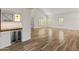 Well-lit living room featuring hardwood floors and a wet bar at 8340 E Rowel Rd, Scottsdale, AZ 85255