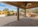 Inviting covered patio with a ceiling fan, built-in grill and pizza oven, ideal for outdoor entertaining at 8340 E Rowel Rd, Scottsdale, AZ 85255