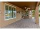 Covered patio with large windows, overlooking lush landscaping and offering seamless indoor-outdoor living at 8340 E Rowel Rd, Scottsdale, AZ 85255